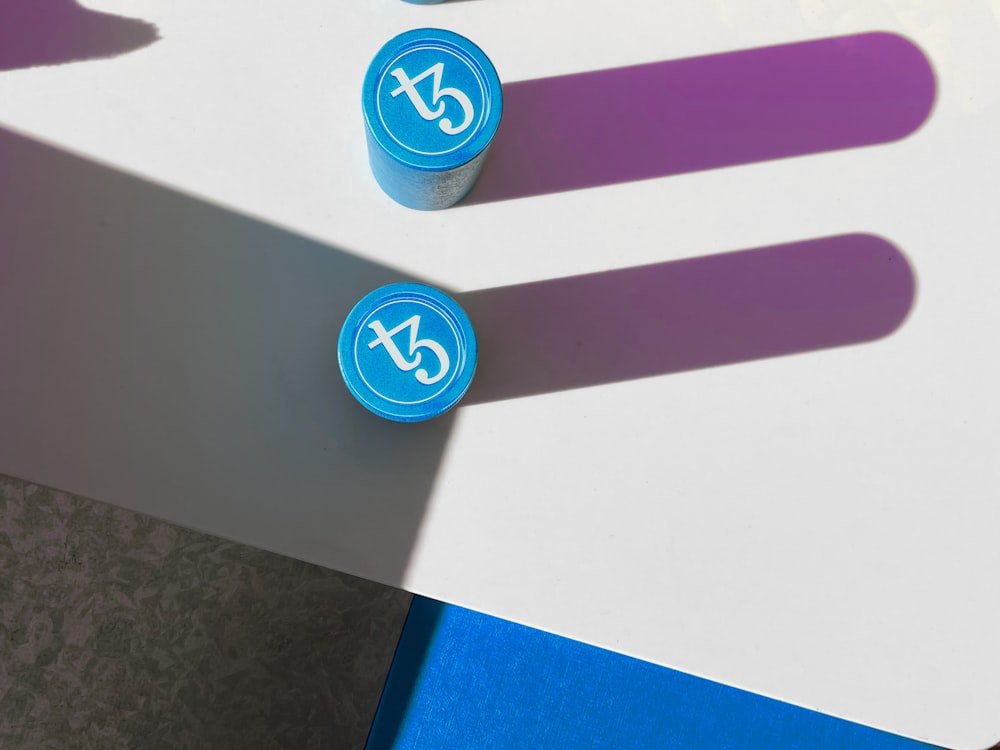 a couple of blue and purple markers sitting on top of a table