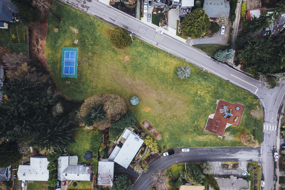 an aerial view of a street and a tennis court