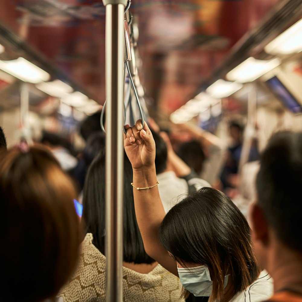 a group of people riding on a subway train