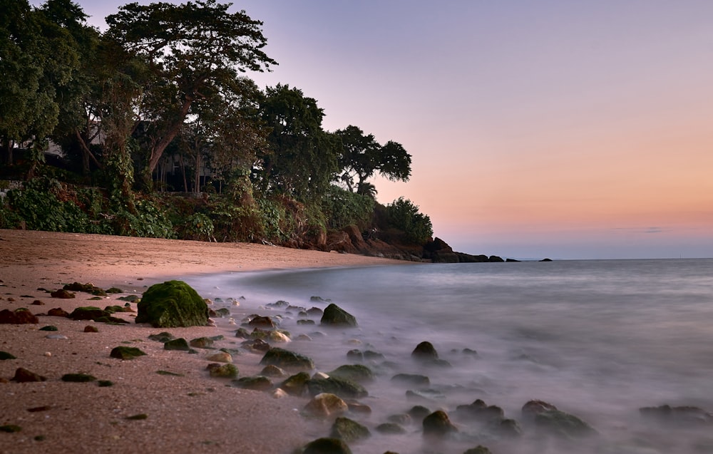 a long exposure of a beach at sunset