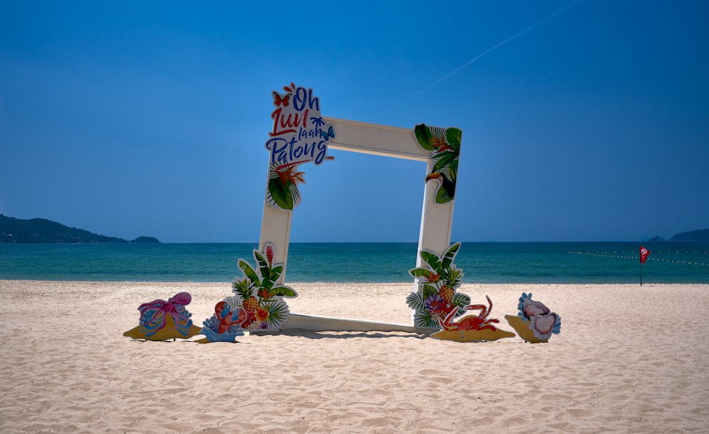 a picture frame sitting on top of a sandy beach