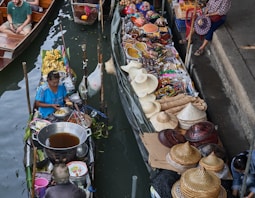 a group of people sitting on boats in a body of water