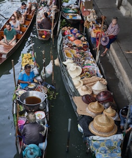 a group of people sitting on boats in a body of water
