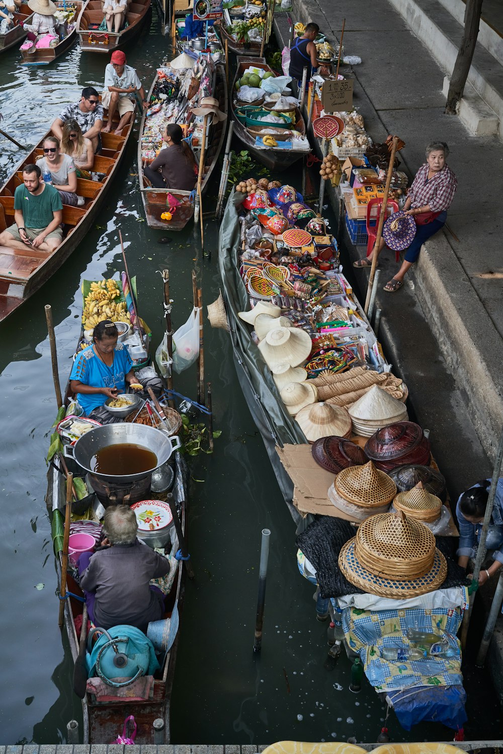 a group of people sitting on boats in a body of water