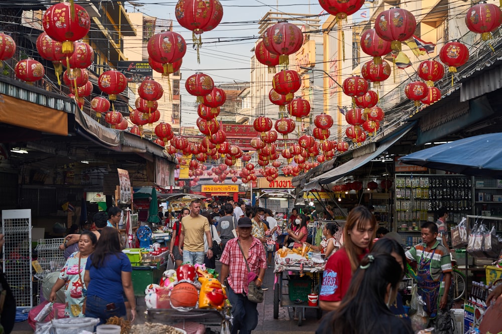 a group of people walking around a market