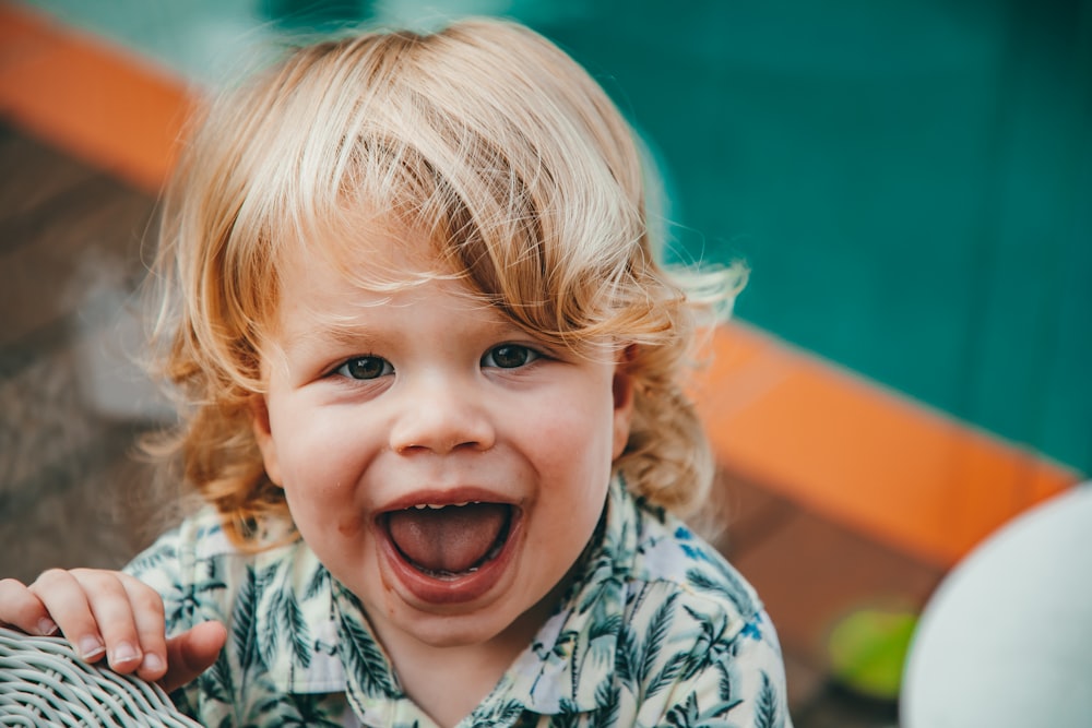 a little boy making a funny face with his mouth open