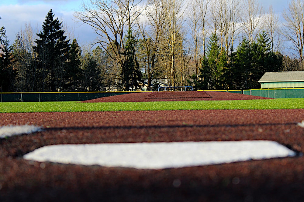 a baseball field with trees in the background