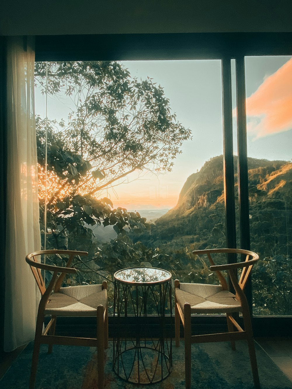 two chairs and a table in front of a window