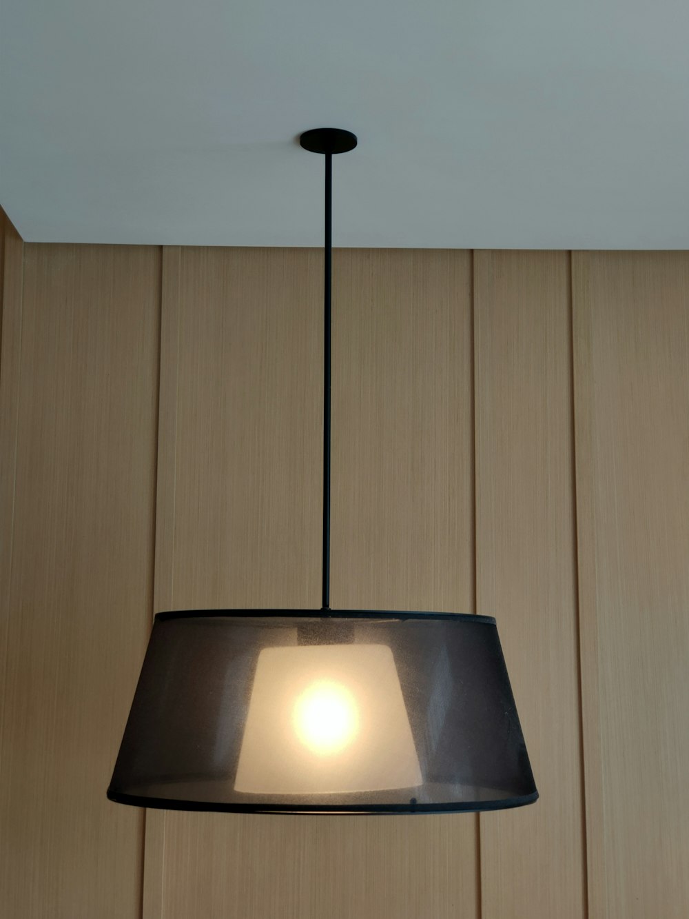 a lamp hanging from a ceiling in a room