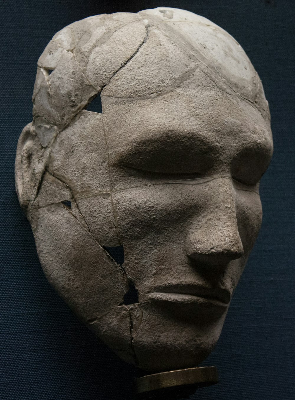 a sculpture of a face made of cement