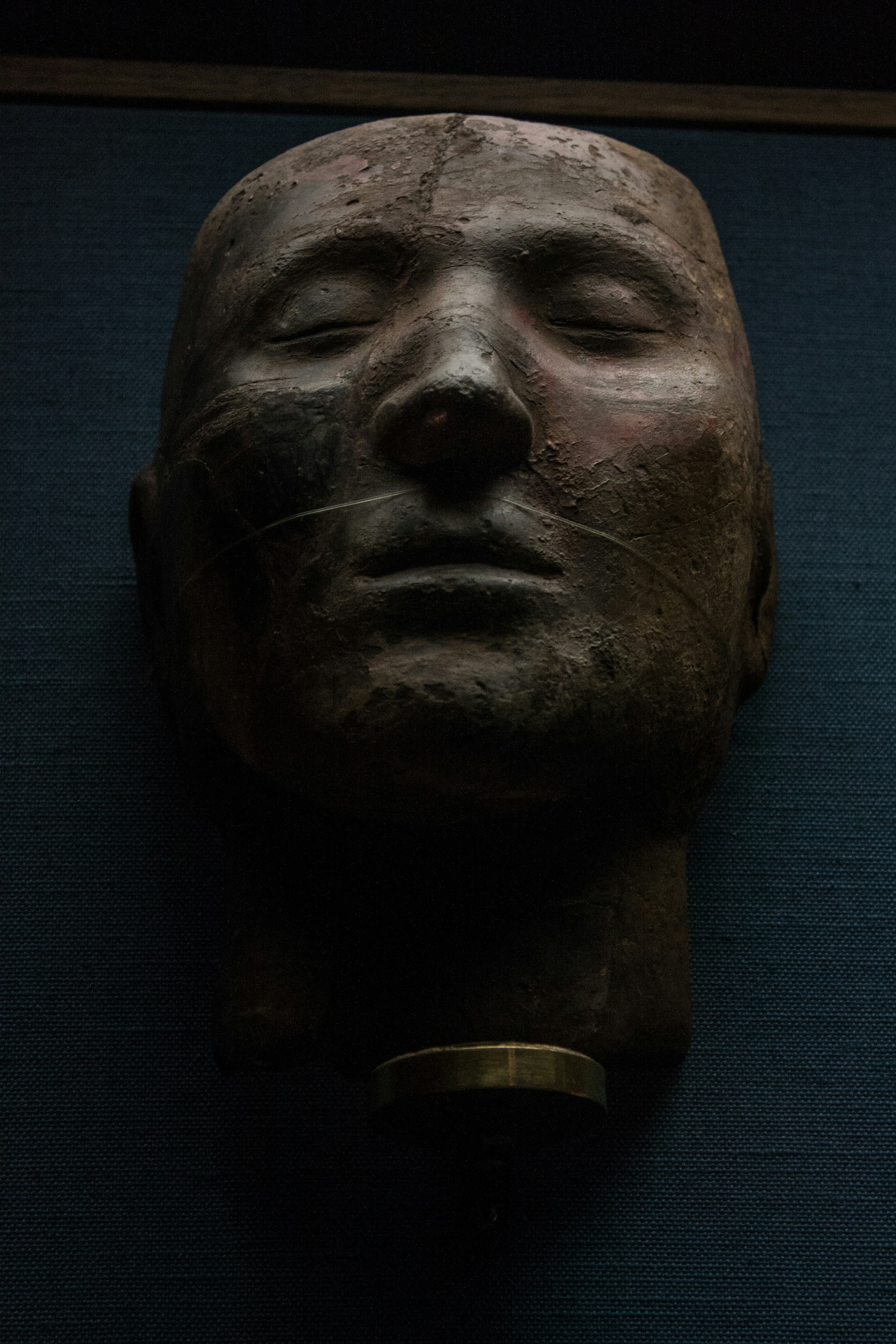 a close up of a mask on a wall