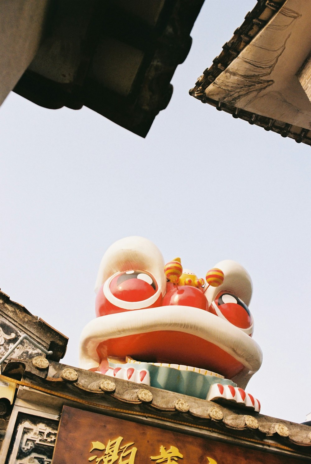 a statue of a dragon on top of a building