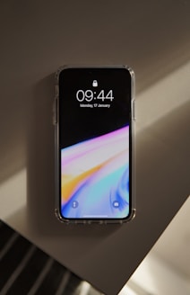 a cell phone sitting on top of a wall