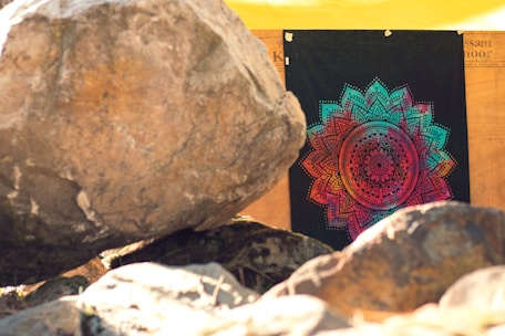 Colorful mandalas and amulets hanging delicately against a soft fabric backdrop.