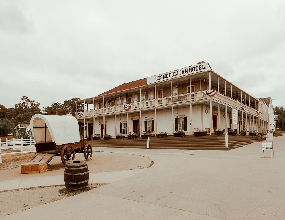 a horse drawn wagon parked in front of a hotel