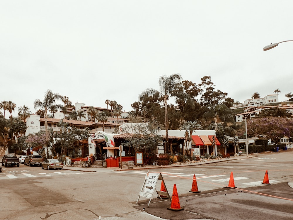 a street corner with traffic cones and buildings