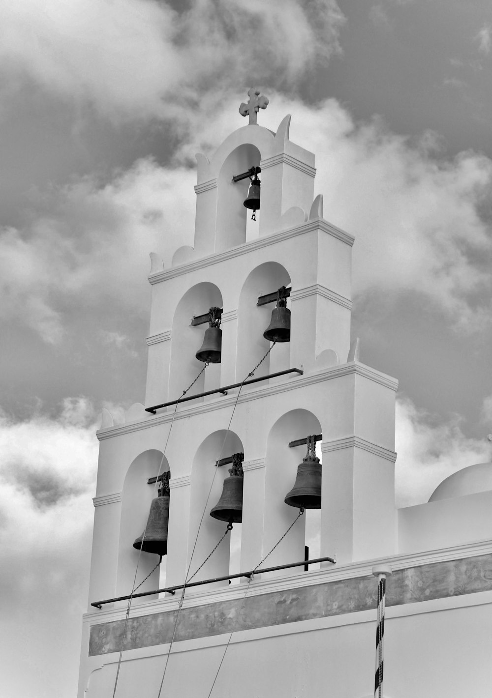 a black and white photo of a bell tower