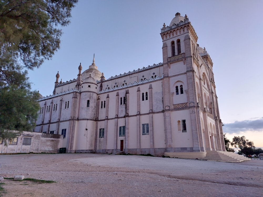 a large white building with a clock tower