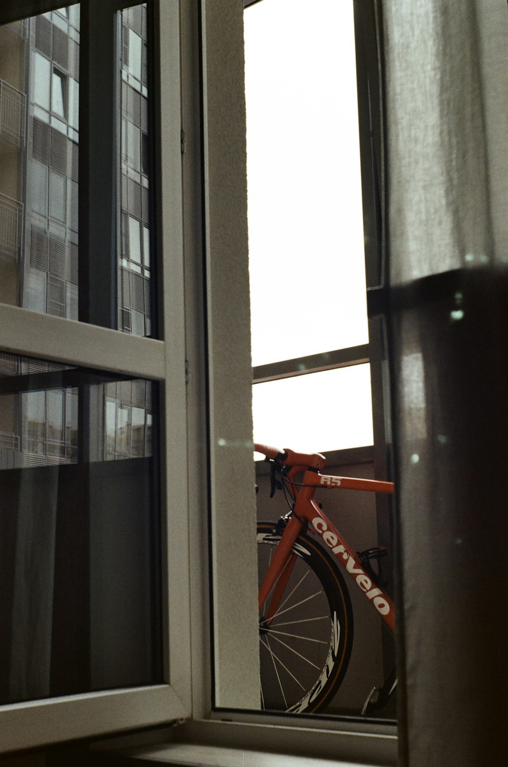 a bicycle is parked next to a window