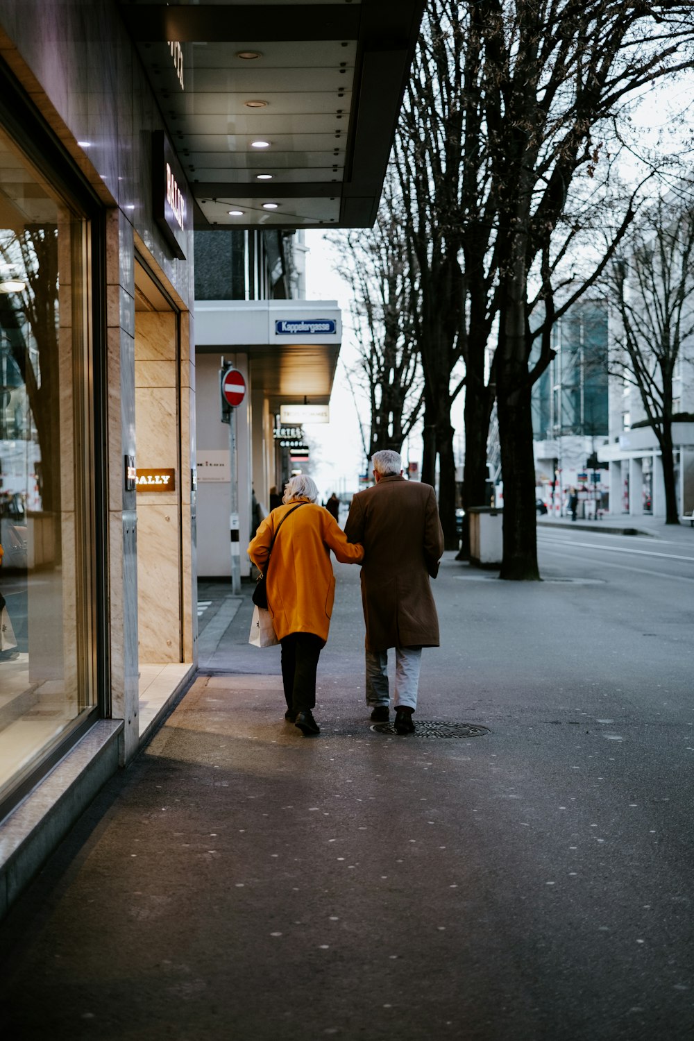 a couple of people walking down a street