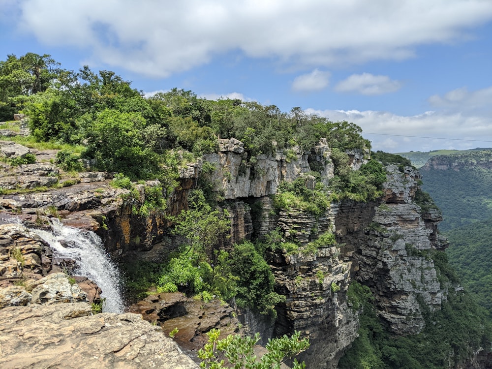 a view of a waterfall from a high cliff