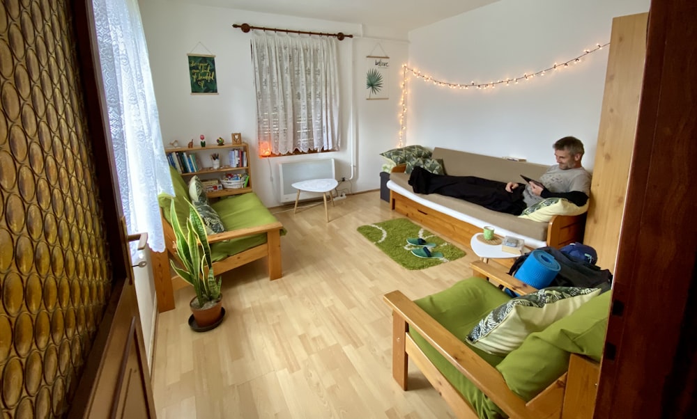 a man sitting on a couch in a living room