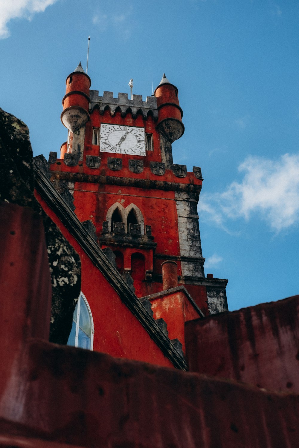 a red tower with a clock on the top of it