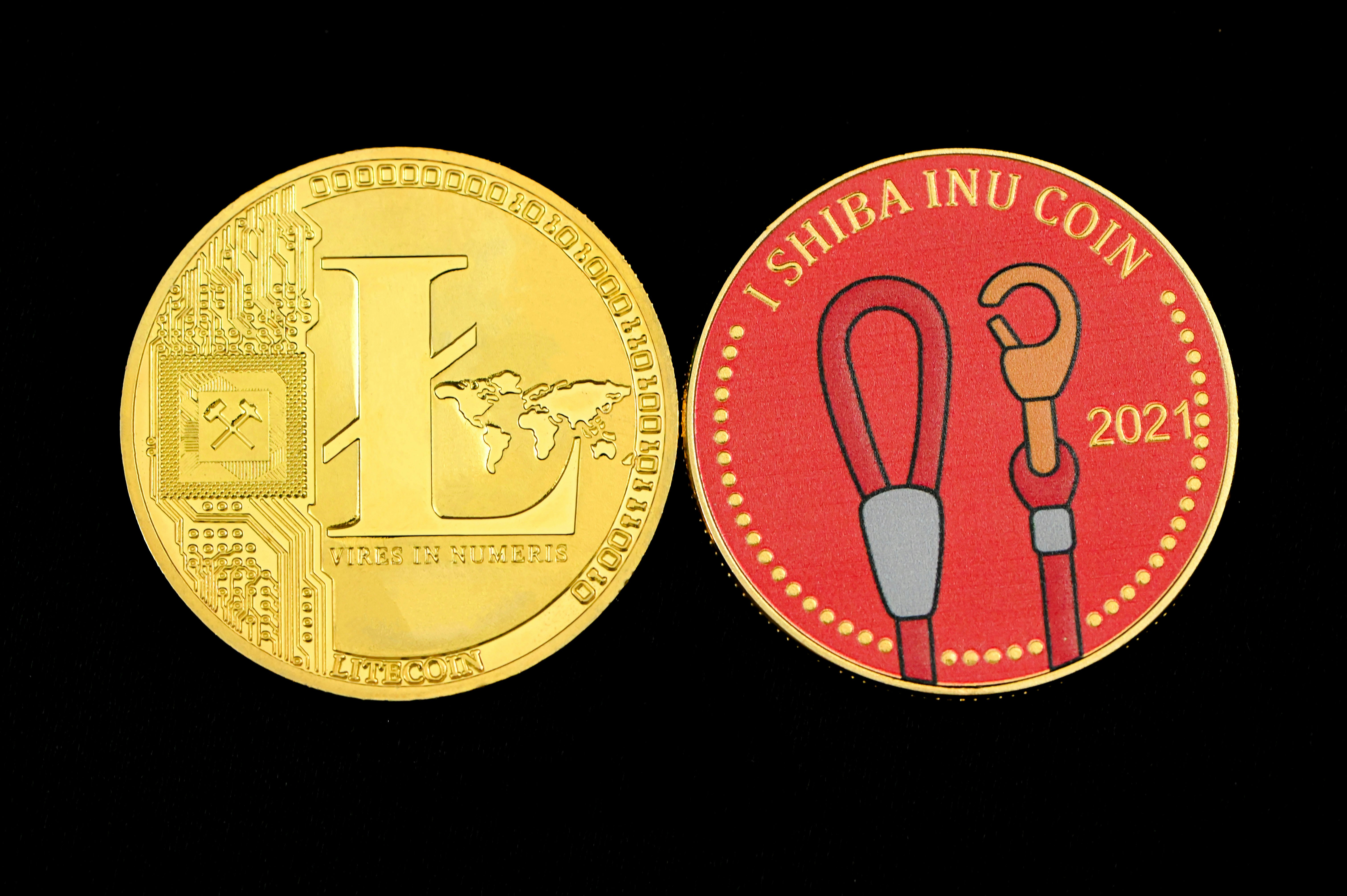 Litecoin and SHIB coin on a dark surface