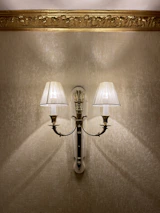 Classic wall sconce highlighting a sophisticated living room corner.