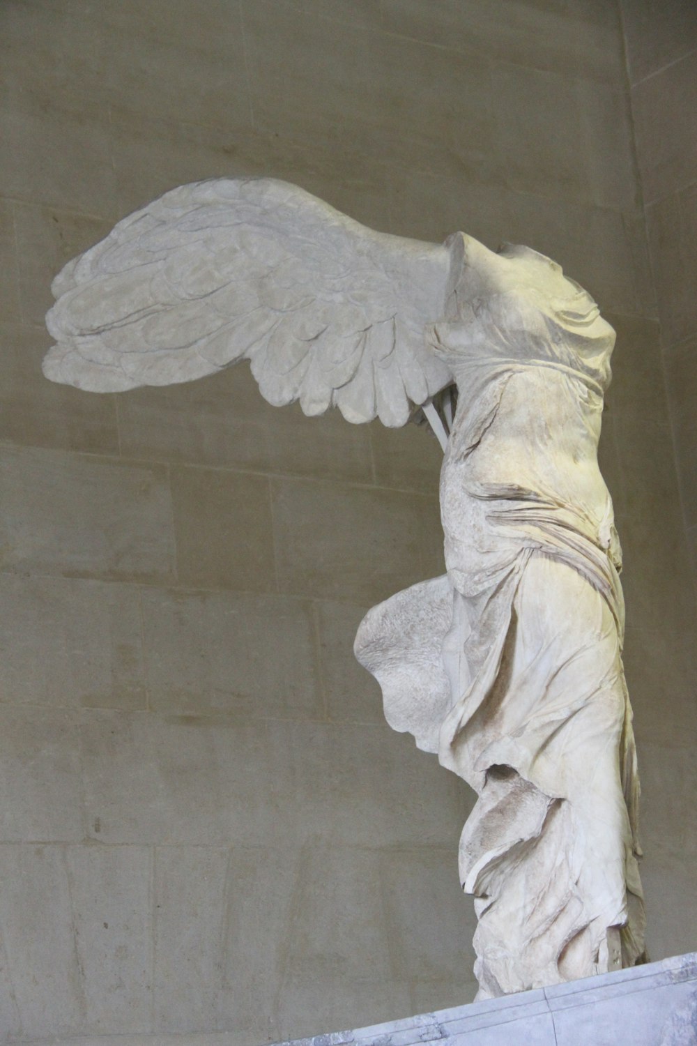 a statue of a woman with wings on a pedestal