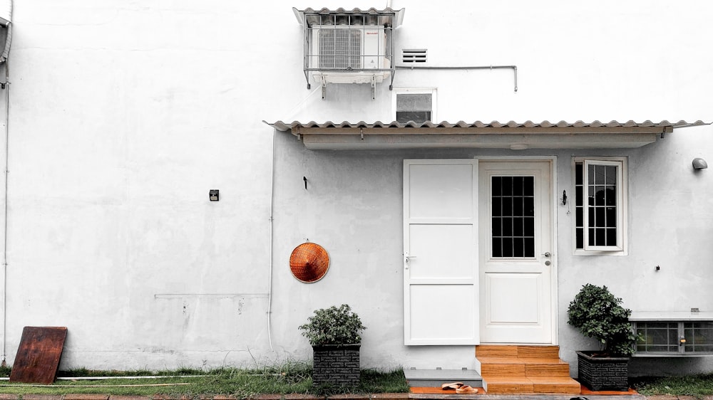 a white house with a white door and window