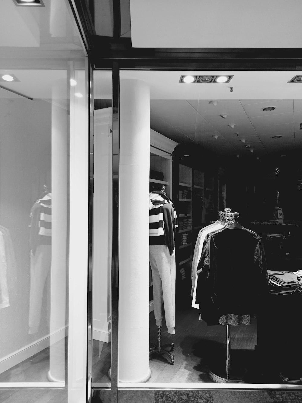 a black and white photo of a clothing store