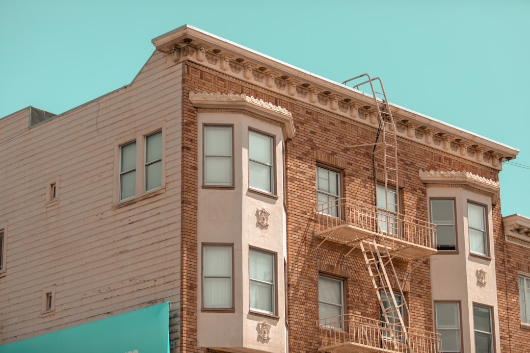 a brick building with a fire escape on the top of it,