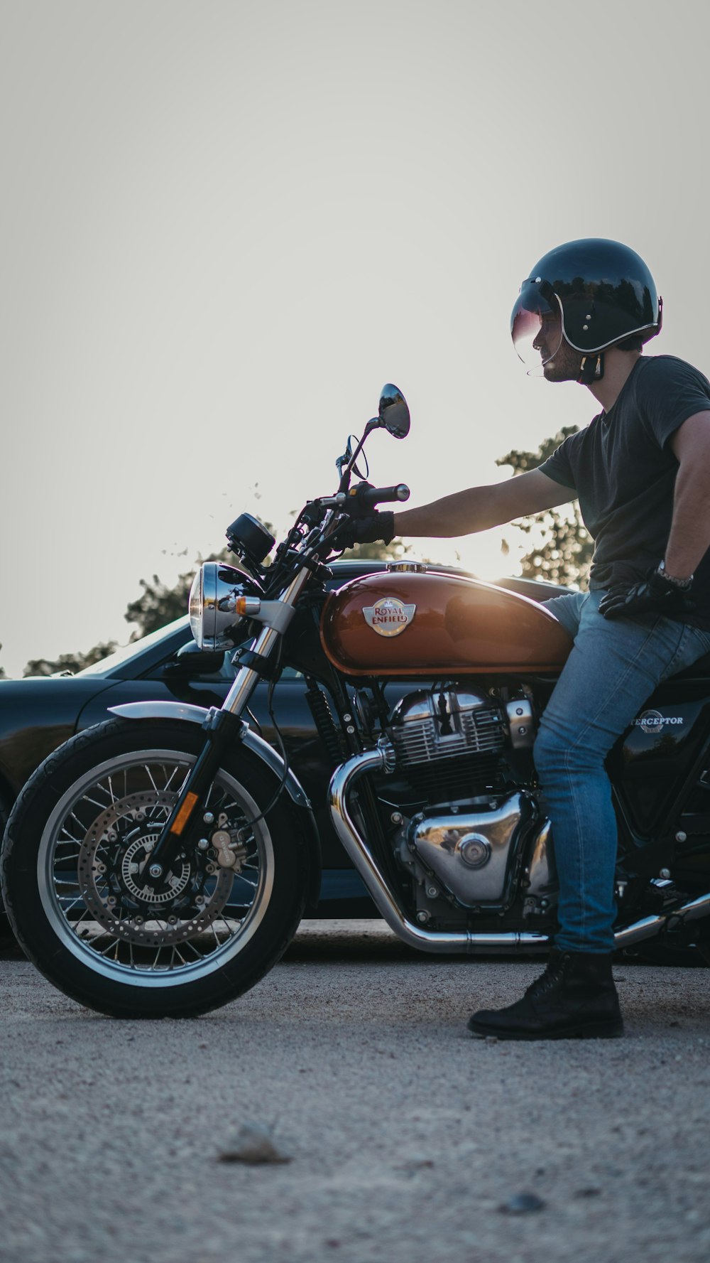 a man wearing a helmet sitting on a motorcycle