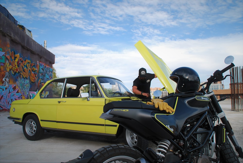 a yellow motorcycle parked next to a yellow car