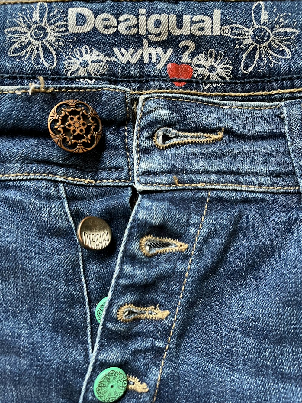 a pair of jeans with buttons on them