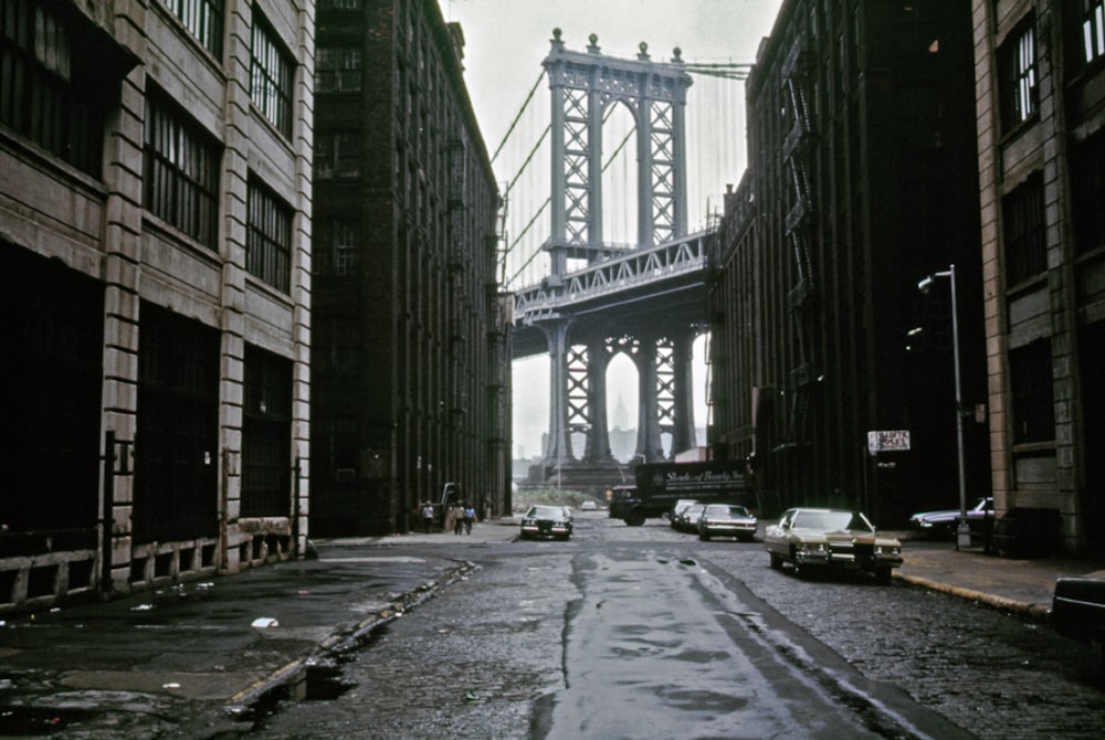 a city street with a bridge in the background