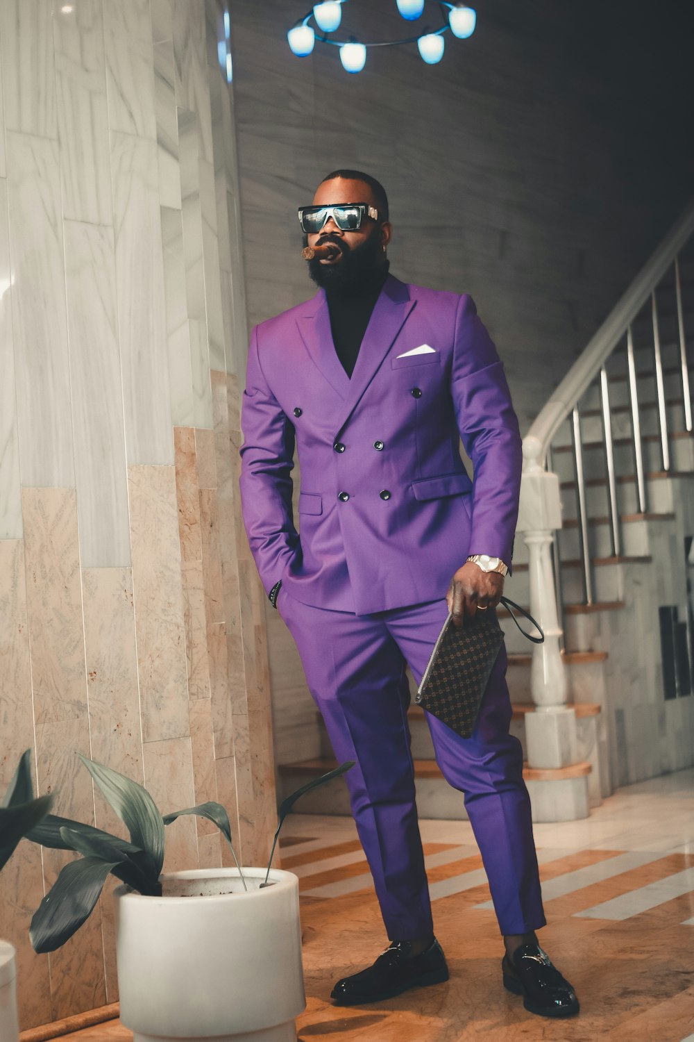 a man in a purple suit and sunglasses