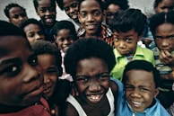 A joyful children's choir singing together with bright smiles.