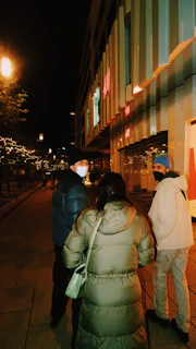 Nighttime street scene featuring a group in money & bitchies streetwear.