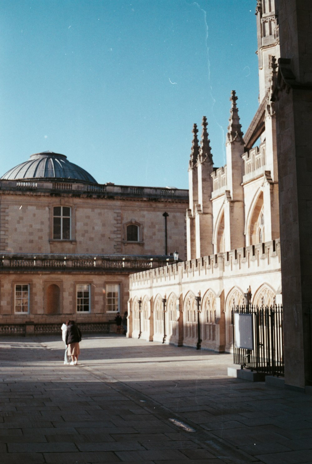 a couple of people standing in front of a building