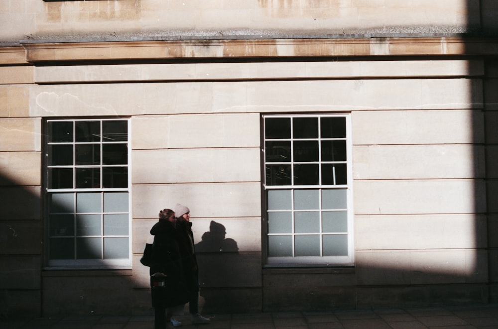 a couple of people standing in front of a building