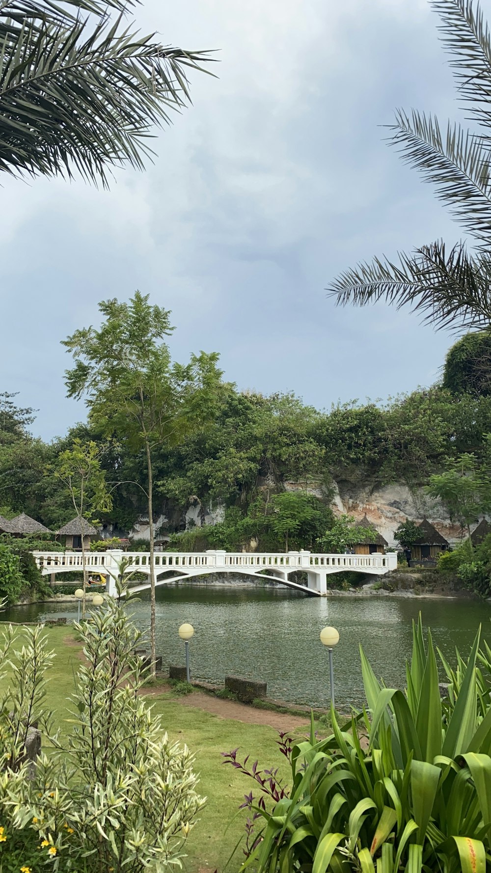 a bridge over a body of water surrounded by trees