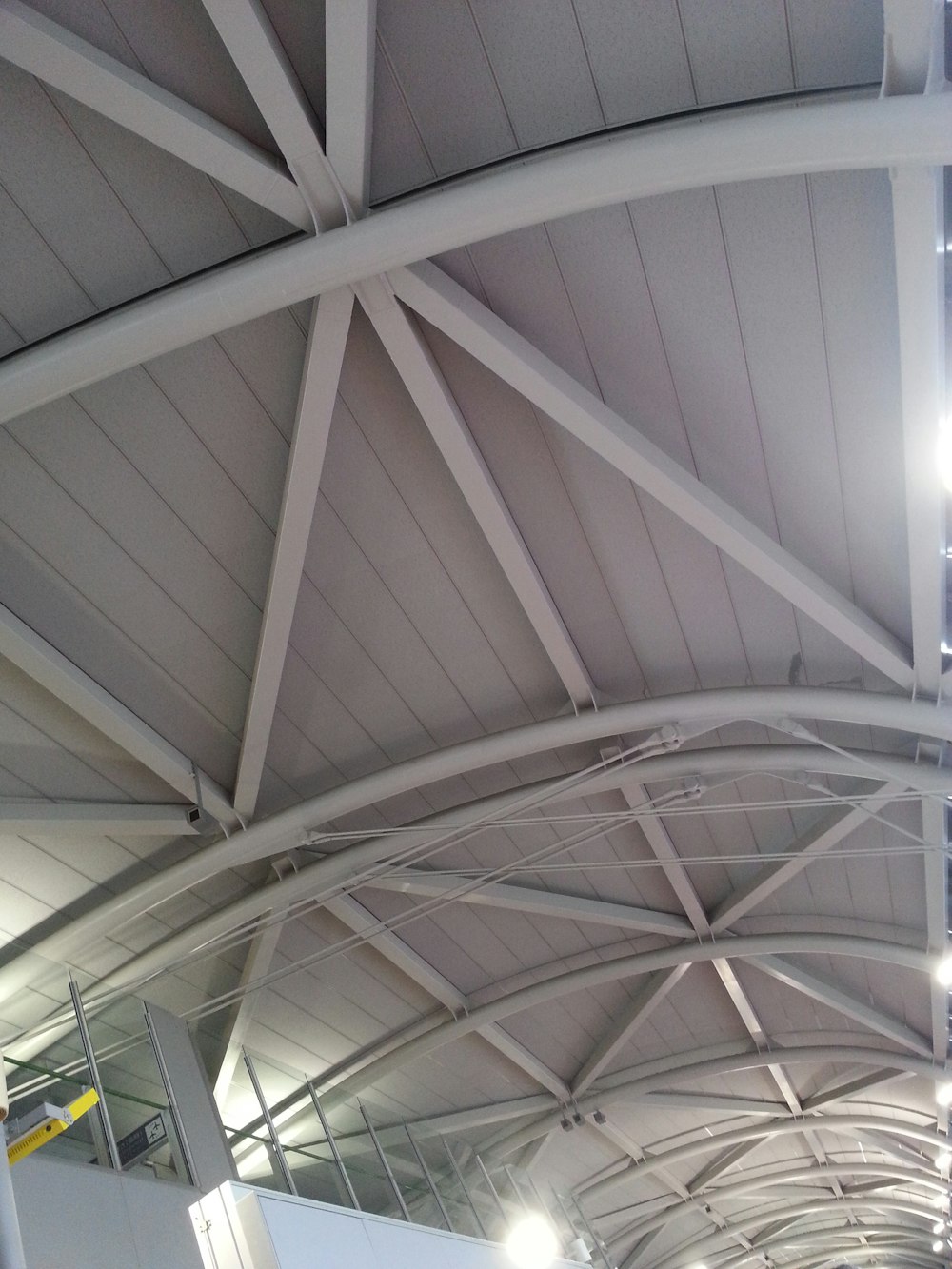 the ceiling of a large building with a clock on it