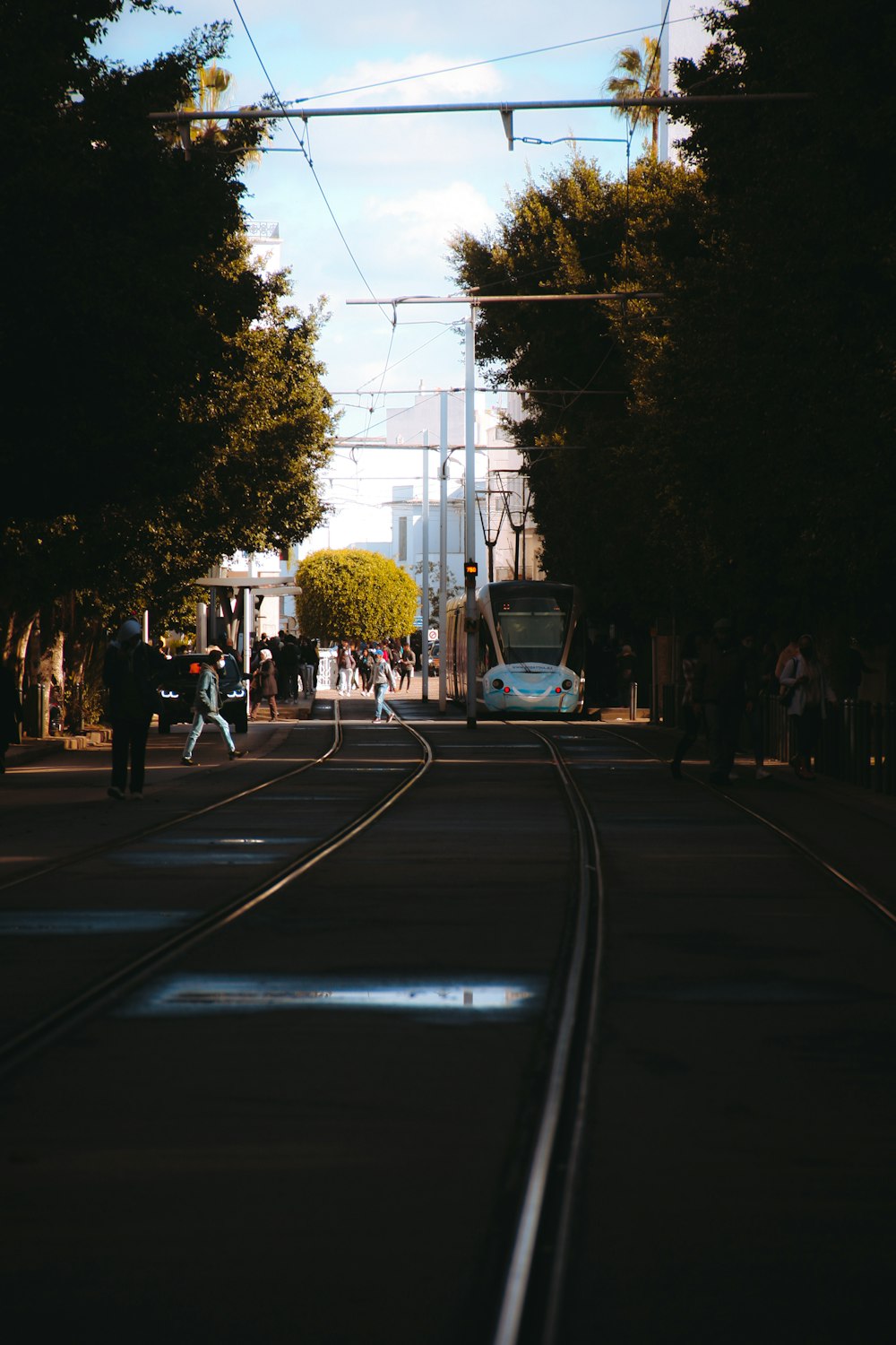 a train track with people walking on it