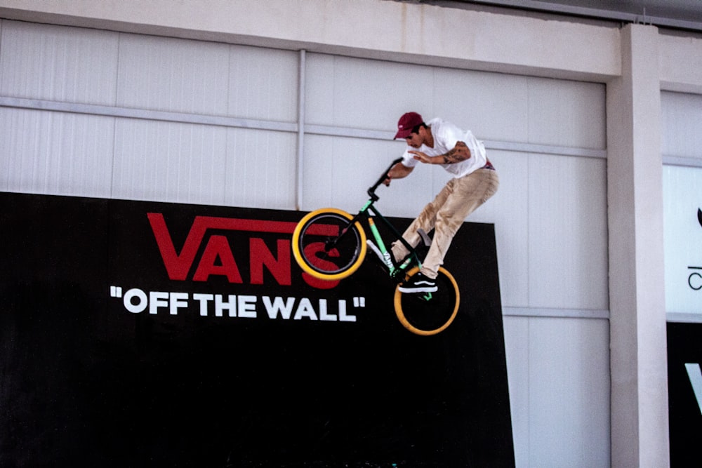 a man riding a bike on top of a wall