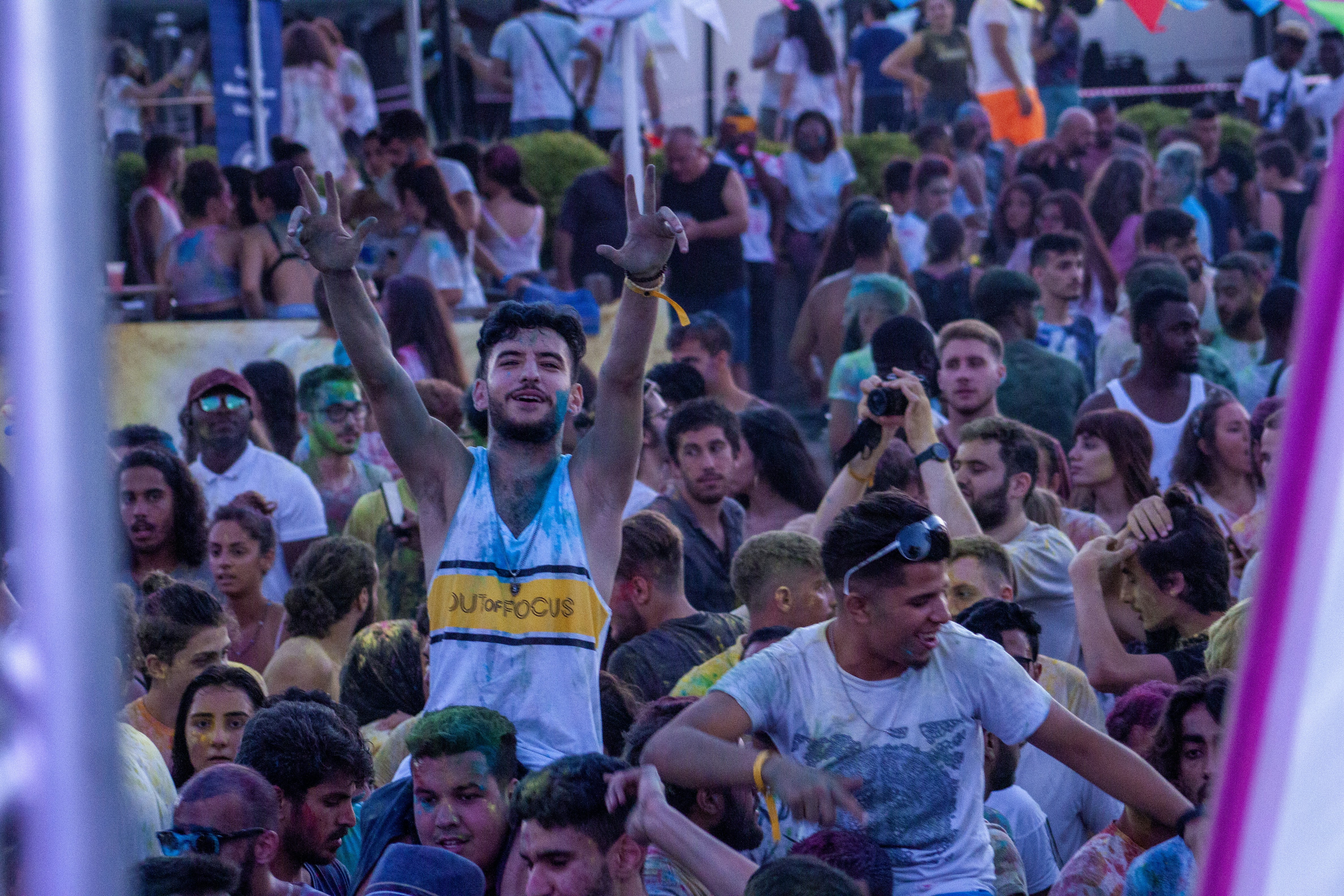 a crowd of people standing around each other