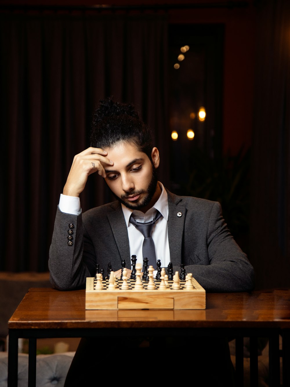 a man wearing a suit and tie sitting at a table