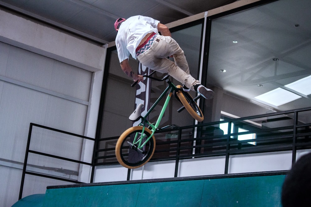 a man jumping in the air doing a trick on a skateboard