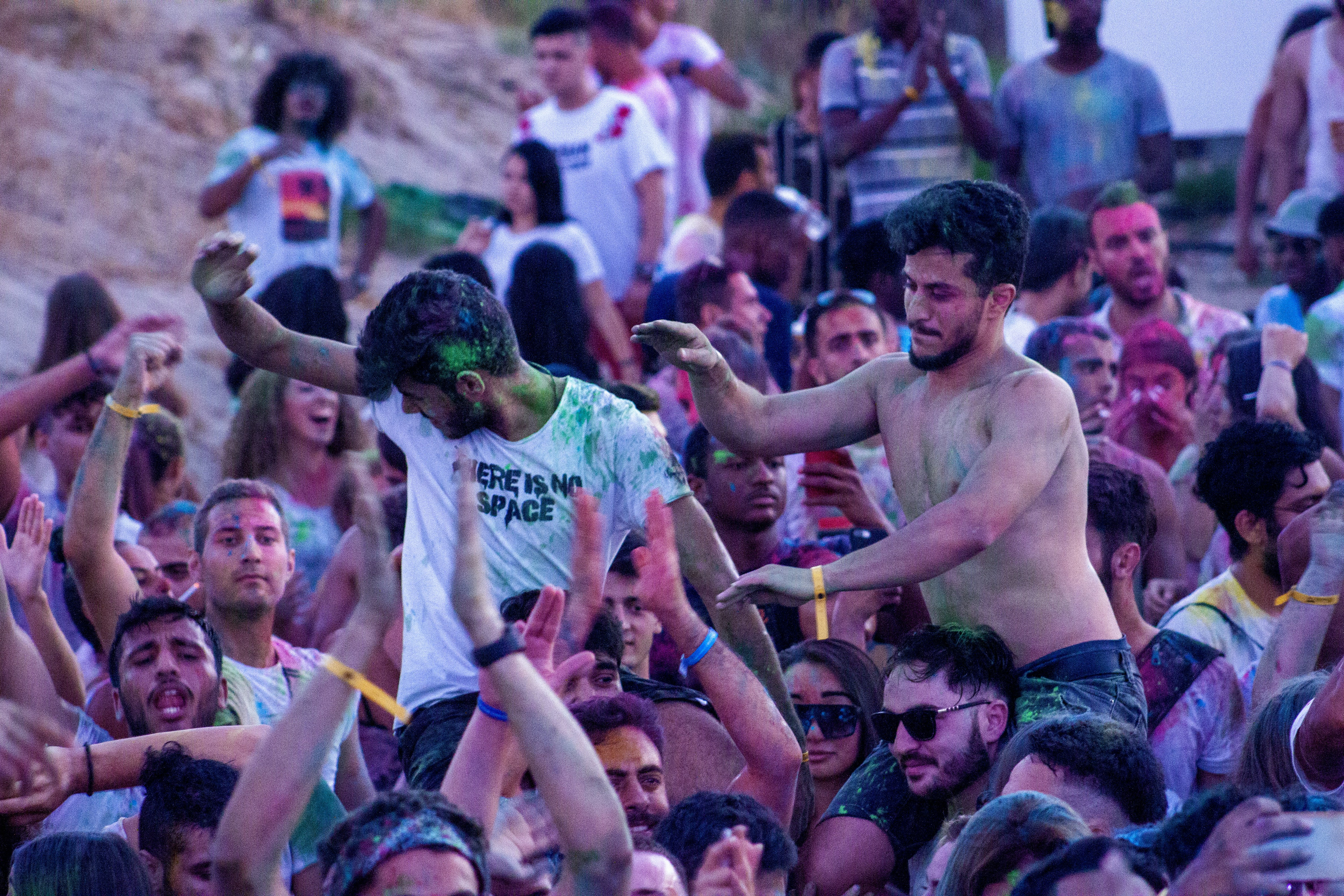 a group of people playing frisbee in front of a crowd